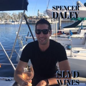 Spencer Daley drinking wine on a boat